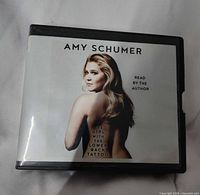 Front cover of audiobook case showing title and author image