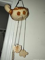 Planter hanging showing underside and dangling ornaments