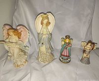 Four angel figurines side by side