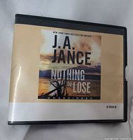 Front cover of audiobook case showing title, author