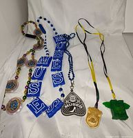 All five necklaces arranged on white backdrop