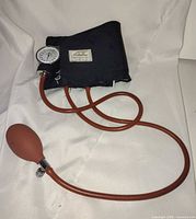 Full view of sphygmomanometer showing cuff, tubing, bulb and gauge