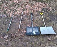Four long-handled tools laid out: two rakes and two snow shovels