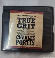 Front of audiobook case showing title, author and publisher
