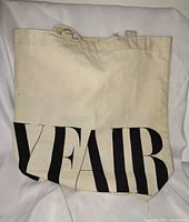 Front view showing beige canvas and partial "V FAIR" print