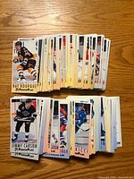 Stacks of 1993-94 Fleer Power Play hockey cards on wooden surface