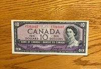 Obverse of 1954 Canadian $10 bill showing portrait, serial number 7263047, signatures