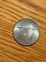 Reverse view showing flying Canada goose design and inscriptions