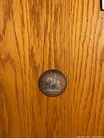 Reverse side showing mountie on horseback design, date and denomination