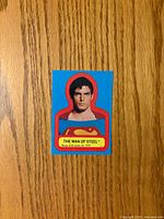Front of die-cut Superman sticker showing image, shield and caption