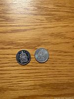 Obverse sides of both 1999 and 2000 Canada 50-cent coins