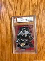 Front of sealed Ed Belfour stick card showing player image, stick piece and serial number