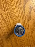 End view of sealed roll showing commemorative V-torch nickel