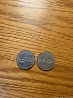 Front faces of both 1968 Canadian dollar coins showing canoe design