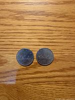 Reverse side showing Voyageur canoe design and year 1980 on both coins