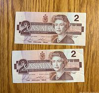 Obverse of both $2 notes showing Queen Elizabeth II portrait