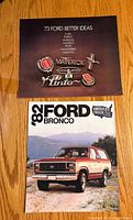 Front covers of both brochures: 1973 Ford Better Ideas and 1980/82 Ford Bronco