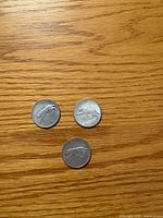 Three 1967 Canadian bobcat quarters reverse side