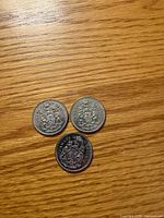 Three 1969 Canada 50¢ coins reverse side showing coat of arms