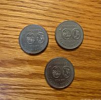 Three Winnipeg Centennial dollars reverse side showing 100 and city design