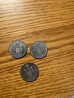 Three reverse sides showing Canadian coat of arms