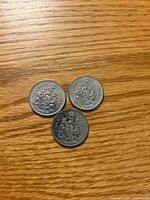 Reverse sides showing Canadian Coat of Arms on all three coins