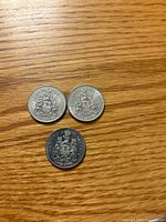 Three coins reverse side with Coat of Arms visible