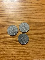 Three 1981 Canadian 50-cent coins reverse side showing coat of arms