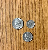 Obverse sides of the 1965 quarter, 1967 dime, 1965 nickel