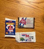 Front view of all three sealed packs showing titles and graphics