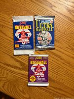 Front view showing three sealed baseball card packs: Score 1990 Rookie & Traded, Fleer Ultra 1991, Score 1991 Series 2