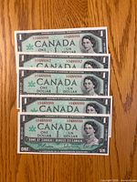 Obverse of five consecutive 1967 Canadian $1 notes