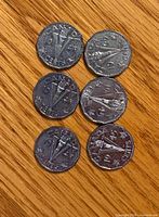 Six 1945 Canadian Victory nickels, reverse side showing torch and V