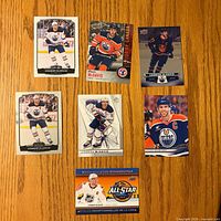 Fronts of seven Connor McDavid cards laid out on table