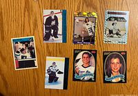 Fronts of six cards showing gold foil, blue border, red bar, autograph scene, kneeling pose and portrait