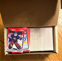 Open box showing stack of approximately 300 Score 1991-92 hockey cards, Glenn Healy card on top