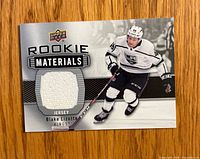 Front of card showing player image, Rookie Materials header, jersey swatch