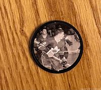 Front of coin showing Bobby Orr action photo