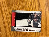 Front of trading card showing player image and jersey swatch
