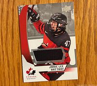 Front of trading card showing player image and embedded jersey swatch