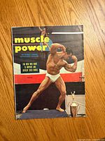 Front cover showing title, date and bodybuilder image