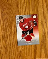 Front of jersey card with player image, jersey swatch and brand logo
