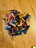 Pile of assorted soft plastic fishing lures spread on wooden surface