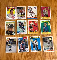 Front view of eleven Topps hockey rookie reprint cards with gold foil stamps
