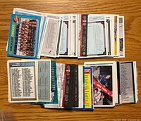 Stacks of assorted checklist trading cards spread on table