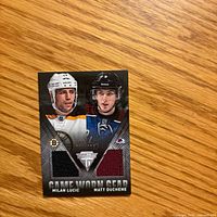 Front of the Panini Game Worn Gear card showing player images and two jersey swatches