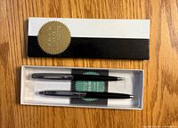 Pen and pencil set in open original box with lid beside
