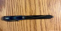 Full view of closed pen showing cap pattern and barrel