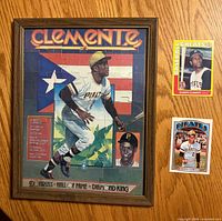 Front of framed puzzle and fronts of both Roberto Clemente cards