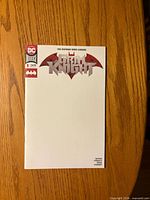 Front of comic showing blank white cover with logo and issue details